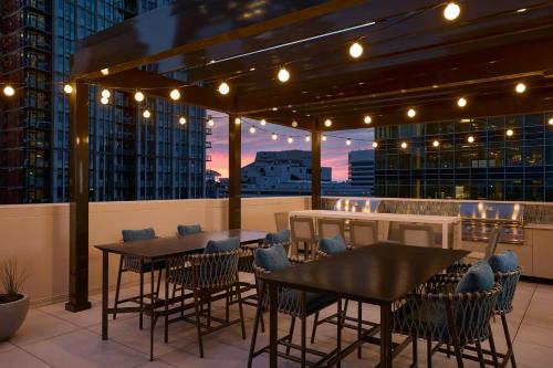 a rooftop patio with tables and chairs and a view at Residence Inn Bethesda Downtown in Bethesda