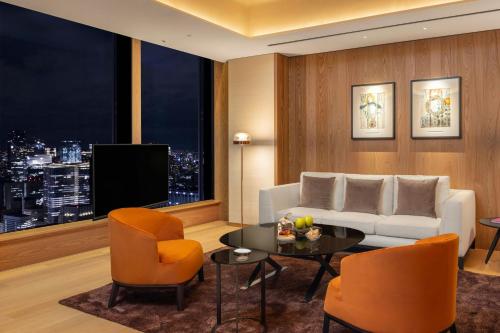a living room with a couch and a table at Bvlgari Hotel Tokyo in Tokyo