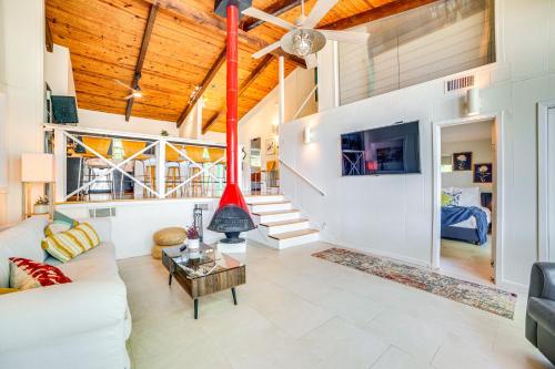 a living room with a white couch and a tv at Waterfront Gem on Cedar Creek Lake with Deck and Games in Enchanted Oaks