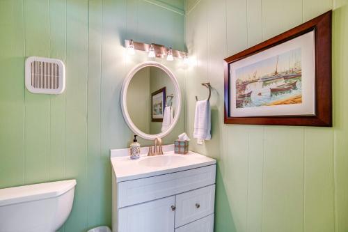 a bathroom with a sink and a mirror at Waterfront Gem on Cedar Creek Lake with Deck and Games in Enchanted Oaks