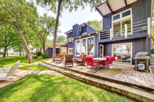 a house with a deck with a table and chairs at Waterfront Gem on Cedar Creek Lake with Deck and Games in Enchanted Oaks