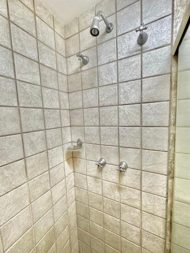 a bathroom with a shower with beige tiles at Flat Residencial Moema garagem internet limpeza e sacada in Sao Paulo