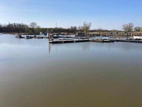 a large body of water with a dock and boats at Anna Falusi Vendégház Sarud in Sarud