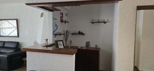 a bar in a living room with a couch at Gomes & Fortunato House in Casais Brancos