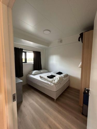 a bedroom with a bed in the middle of it at Nordtoppen in Alta