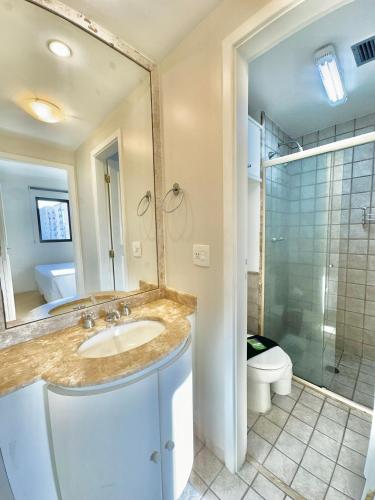 a bathroom with a sink and a shower and a toilet at Maison D Stan Moema with washing machine and daily cleaning in São Paulo