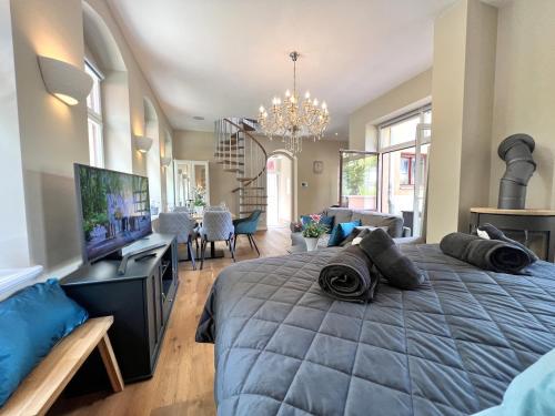 a bedroom with a large bed and a living room at Charmantes Hinterhaus mit Terrasse - zentrale Lage in Dresden