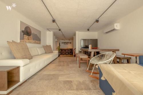 a living room with a white couch and a table at Castillo Grande Bayside Retreat 6BR 2 Homes in Cartagena de Indias
