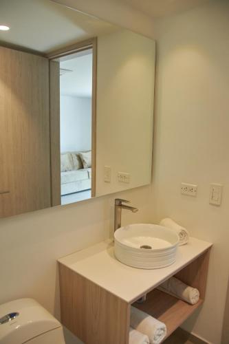 a bathroom with a sink and a mirror at Zafi Hotel in San Andrés