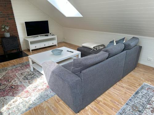 a living room with a couch and a tv at Stintebakken 1 in Arendal