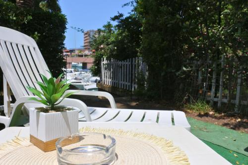 a table with a glass bowl and a plant on it at Villaggio Portorosa - La casetta tra le palme 14 in Torre Forte