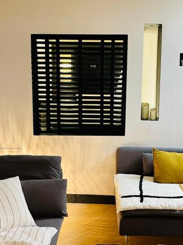 un salon avec un canapé et une fenêtre dans l'établissement Le Marais by Steph, à Paris