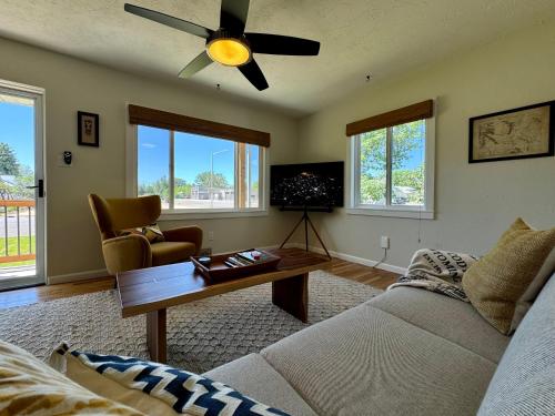 a living room with a couch and a ceiling fan at Cozy Whole Home Mid-Century Hideaway in Cody
