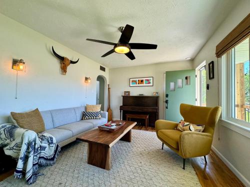 a living room with a couch and a ceiling fan at Cozy Whole Home Mid-Century Hideaway in Cody