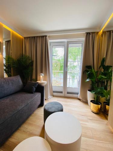 a living room with a couch and a table at Apartament MoLoo I in Ostróda