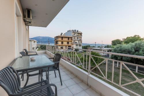 a balcony with a table and chairs and a view at My Nafpaktos Resort in Nafpaktos