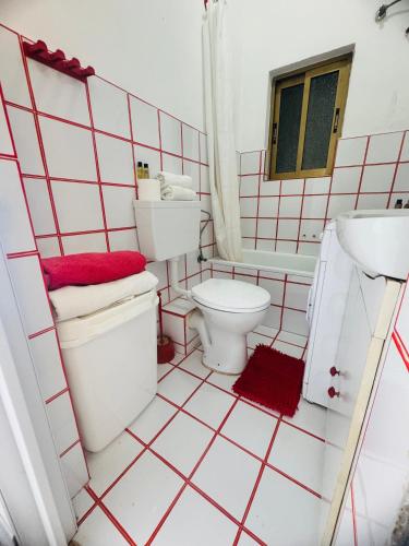 a bathroom with a toilet and a sink at Gozo House in Marsalforn