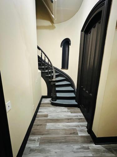 a hallway with a spiral staircase in a building at Spacious Apartment Downtown Albany, NY in Albany