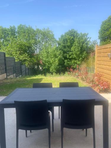 a black table with four chairs sitting around it at La Forge in Cassel