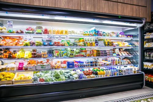 a refrigerator filled with lots of different types of food at Societe Suites By iHost Global in Kuala Lumpur