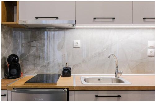a kitchen with a sink and a counter at Ladadika Vibes Studio 2 in Thessaloniki