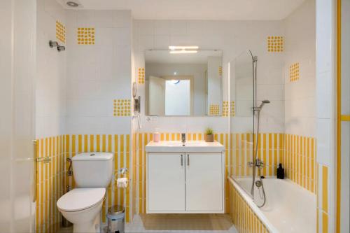 a bathroom with a toilet and a sink and a tub at Atlantic Soul in Playa Blanca
