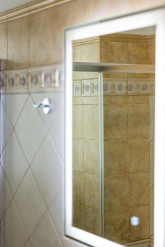 a mirror in a bathroom with a shower at My Nafpaktos Resort in Nafpaktos