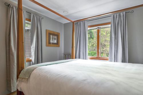 a bedroom with a large bed and a window at Hearth & Timber in Bridgman