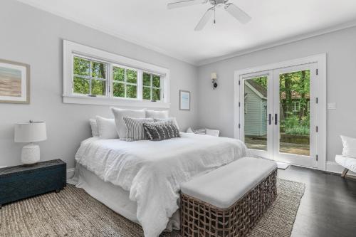 a white bedroom with a large bed and a window at The Ponchartrain in New Buffalo