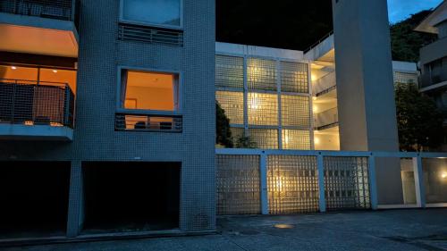 a brick building with a fence in front of it at condominium SAKURA B5 in Hakone