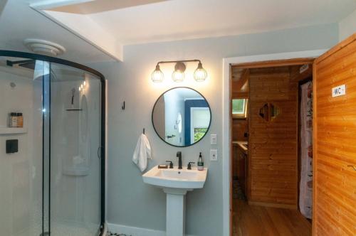 a bathroom with a sink and a mirror at Honeycomb Hideaway by AvantStay Rustic Retreat in Fairview