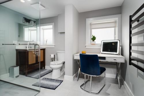 a bathroom with a toilet and a desk with a computer at Ace Properties in Chicago
