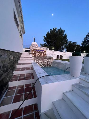 a swimming pool on the roof of a building at Villa relax todo verde natural in Almuñécar