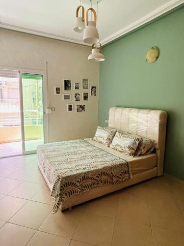 a bed in a room with a green wall at Fès Medina Escape Apartment in Fez