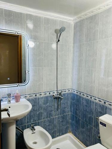 a bathroom with a shower and a toilet and a sink at Fès Medina Escape Apartment in Fez