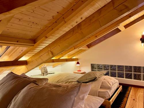 a bedroom with a bed in a loft at Quintinha da Oliveira in Marco de Canavezes