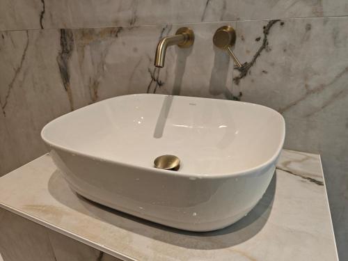 a white sink sitting on a counter in a bathroom at Sun And Roses Siviri in Siviri