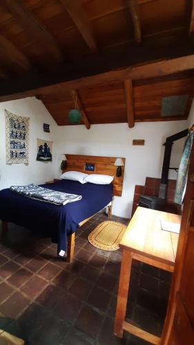 a bedroom with a bed and a table in a room at The Black Sheep Inn in Huamboya