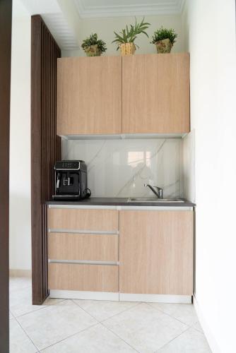 a kitchen with a sink and wooden cabinets at Catherine's Seaside House B in Stómion