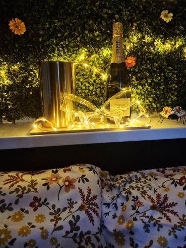 a bottle of wine sitting on a window sill with lights at L'évasion in Chièvres