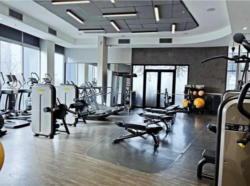 a gym with several treadmills and cardio machines at Stunning City View Apartment Sandton City-The Capital On The Park in Johannesburg