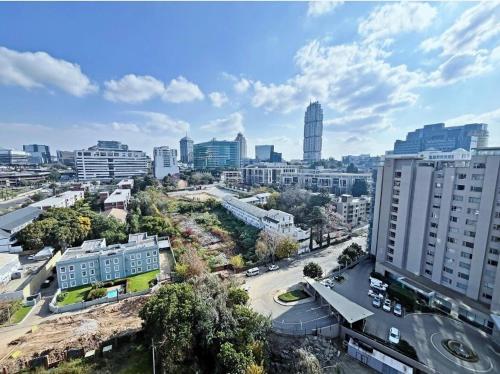 an aerial view of a city with tall buildings at Stunning City View Apartment Sandton City-The Capital On The Park in Johannesburg