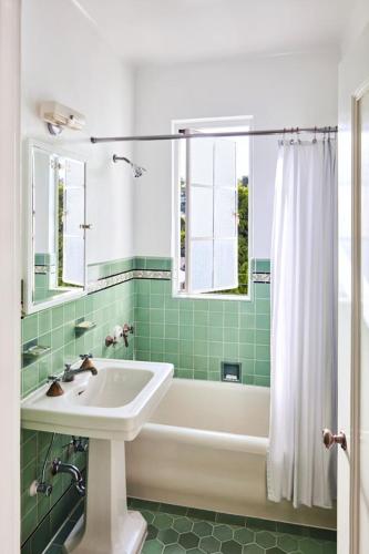a bathroom with a tub and a sink and a bath tub at Chateau Marmont in Los Angeles