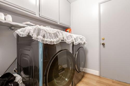 a washing machine with a white curtain on top of it at Los Angeles - Centrally located between Disneyland Universal Studios Beverly Hills and Downtown LA Most ideal city to stay with stunning views and heated pool in Hacienda Heights