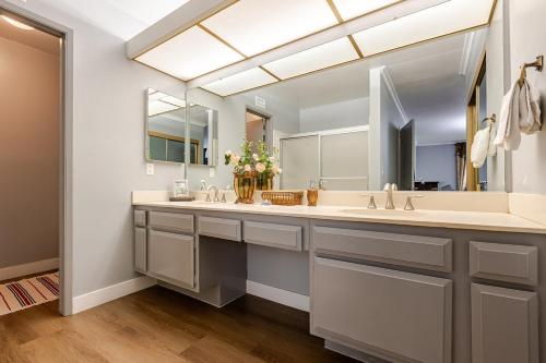 a bathroom with two sinks and a large mirror at Los Angeles - Centrally located between Disneyland Universal Studios Beverly Hills and Downtown LA Most ideal city to stay with stunning views and heated pool in Hacienda Heights