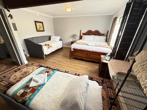 a living room with two beds and a couch at Los Angeles - Centrally located between Disneyland Universal Studios Beverly Hills and Downtown LA Most ideal city to stay with stunning views and heated pool in Hacienda Heights