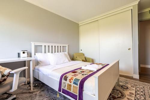 a bedroom with a bed with a desk and a chair at Los Angeles - Centrally located between Disneyland Universal Studios Beverly Hills and Downtown LA Most ideal city to stay with stunning views and heated pool in Hacienda Heights