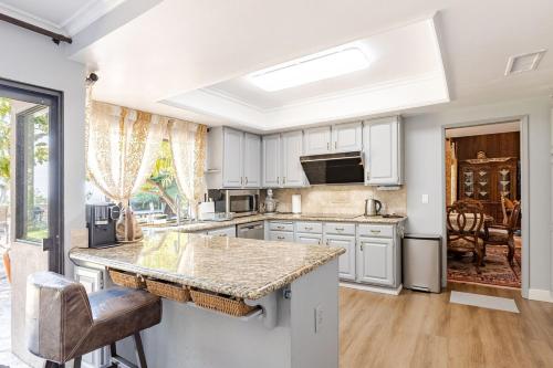 a kitchen with white cabinets and a counter top at Los Angeles - Centrally located between Disneyland Universal Studios Beverly Hills and Downtown LA Most ideal city to stay with stunning views and heated pool in Hacienda Heights