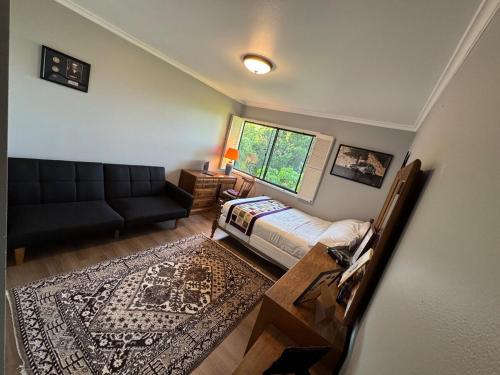 a living room with a bed and a couch at Los Angeles - Centrally located between Disneyland Universal Studios Beverly Hills and Downtown LA Most ideal city to stay with stunning views and heated pool in Hacienda Heights