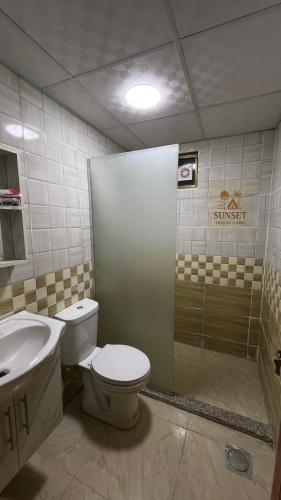 a bathroom with a toilet and a sink and a shower at Sun Set Luxury Camp in Disah